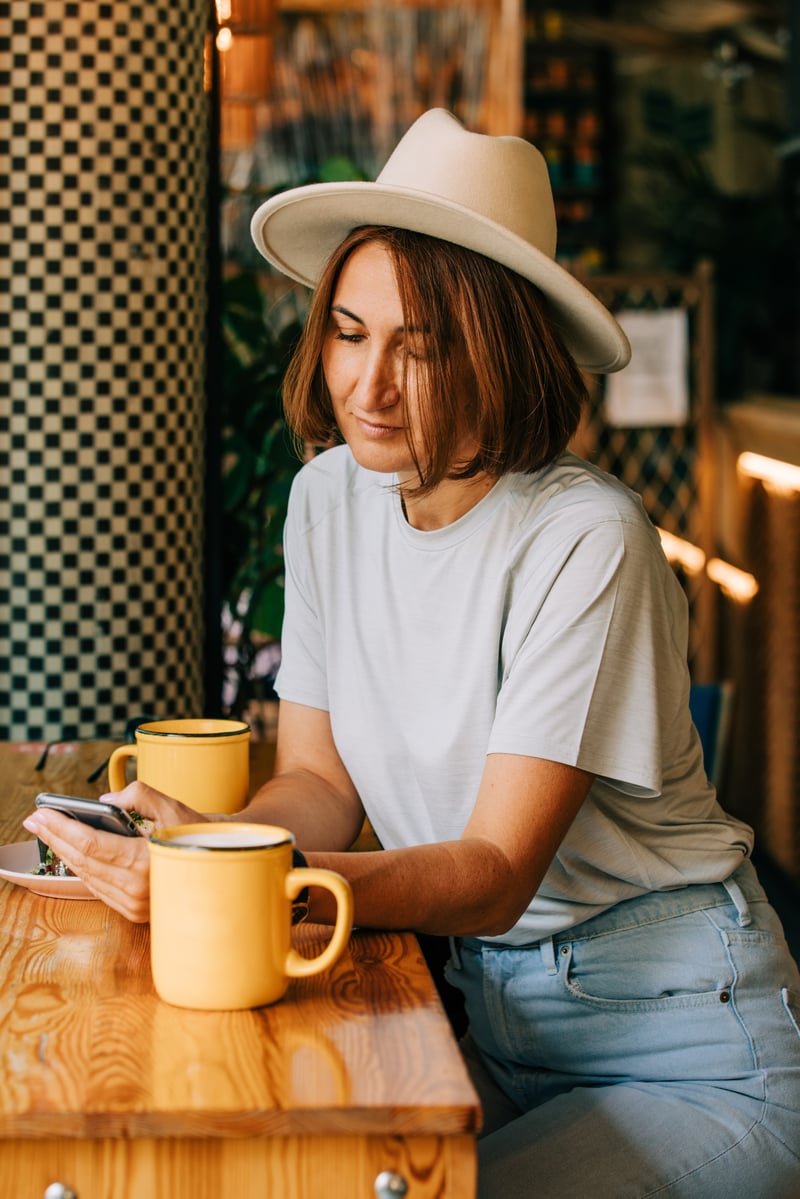 stylish-fifty-year-old-woman-drinking-coffee-in-a-2022-09-28-00-35-08-utc