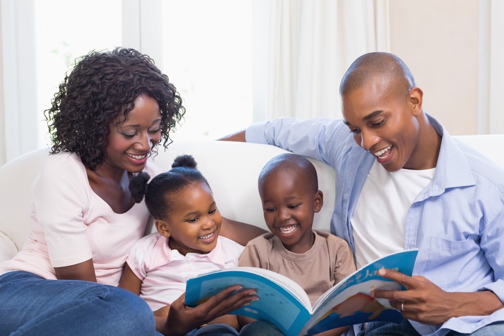 family with children reading a book