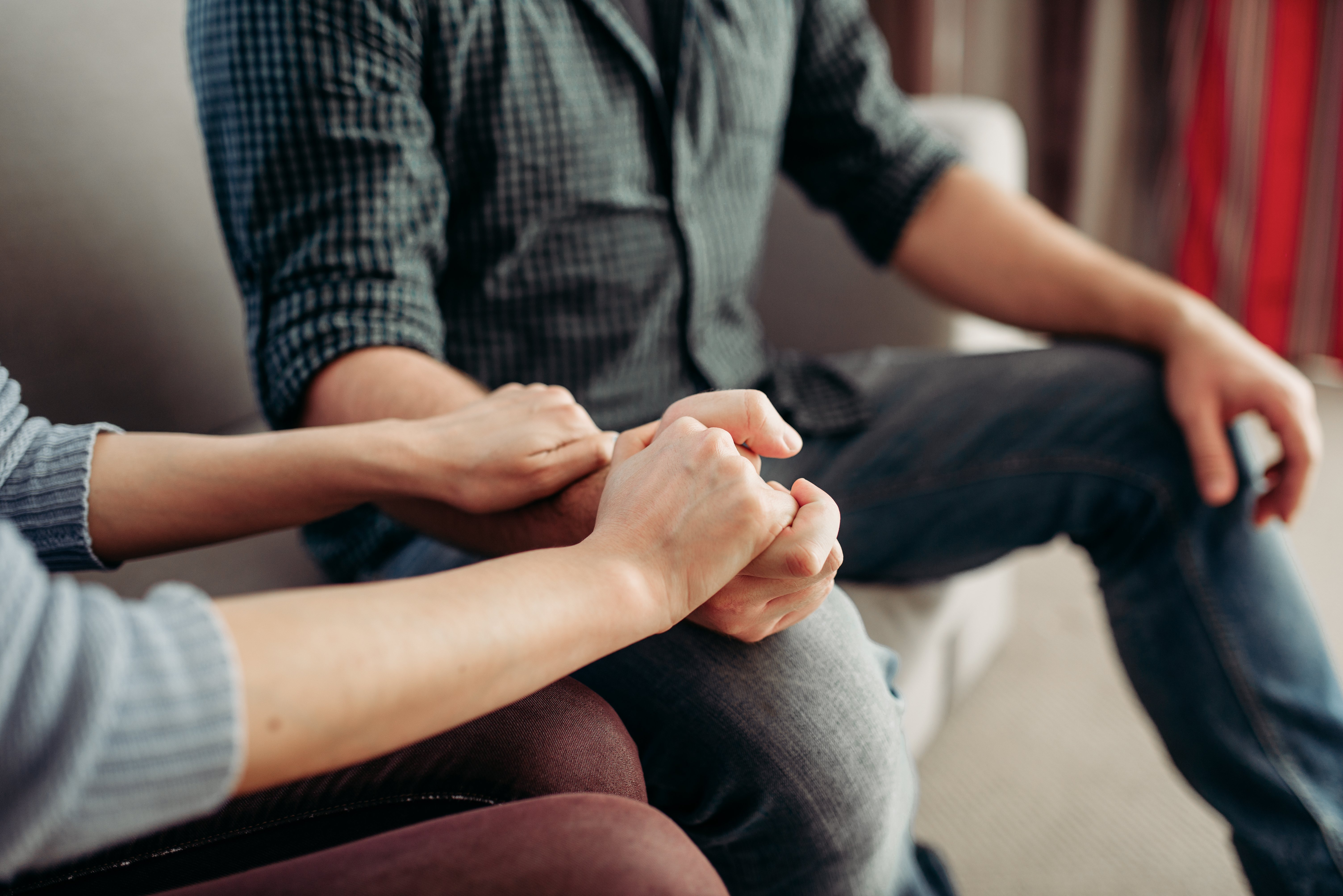 couple holding hands at therapy session