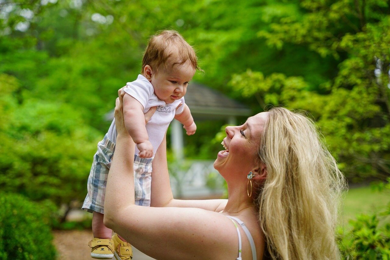 A woman raising  her newborn