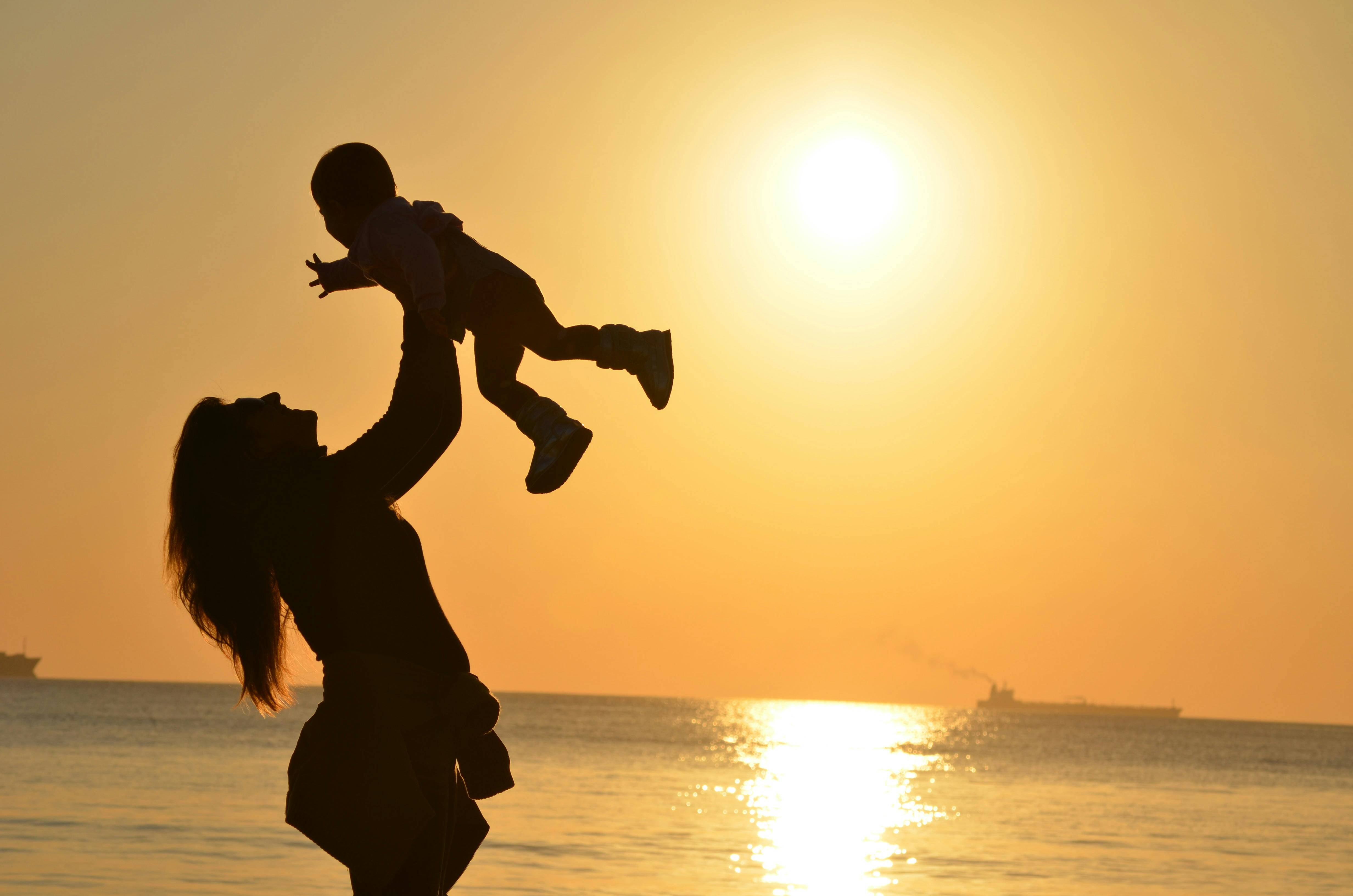 A woman lifting her baby in the air